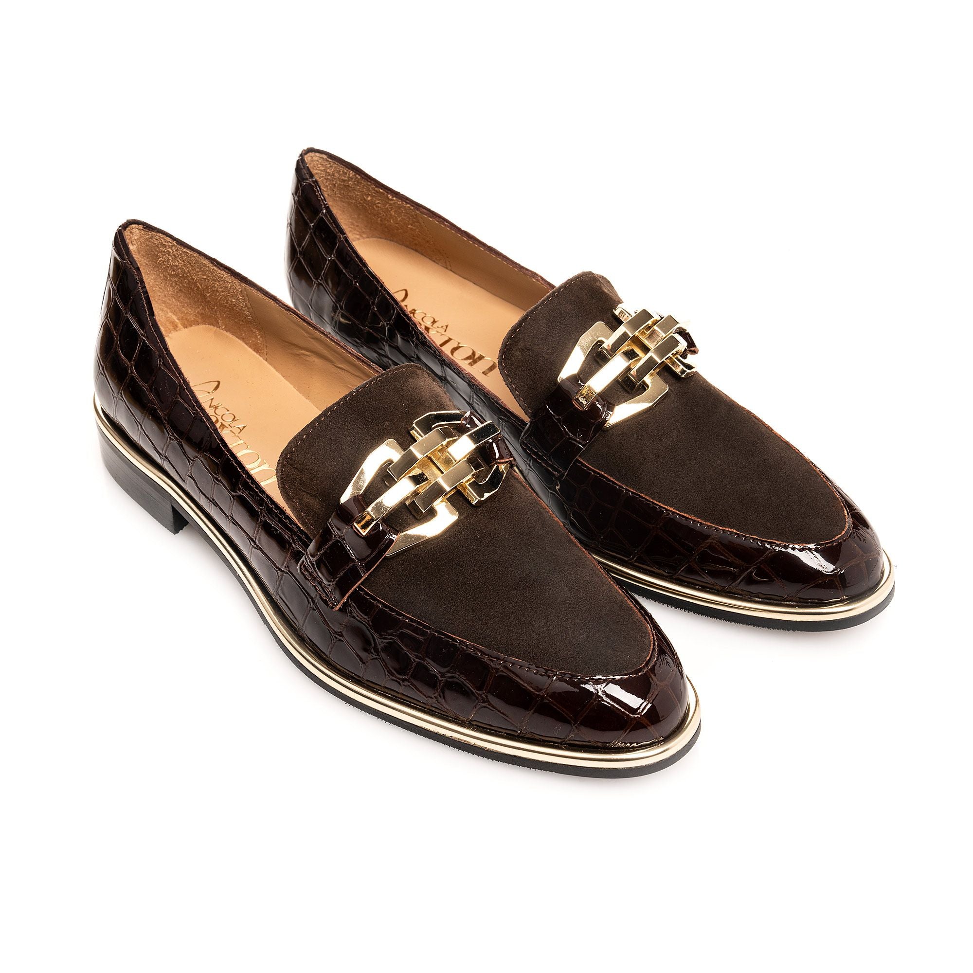 Brown loafers with gold accents on a white background