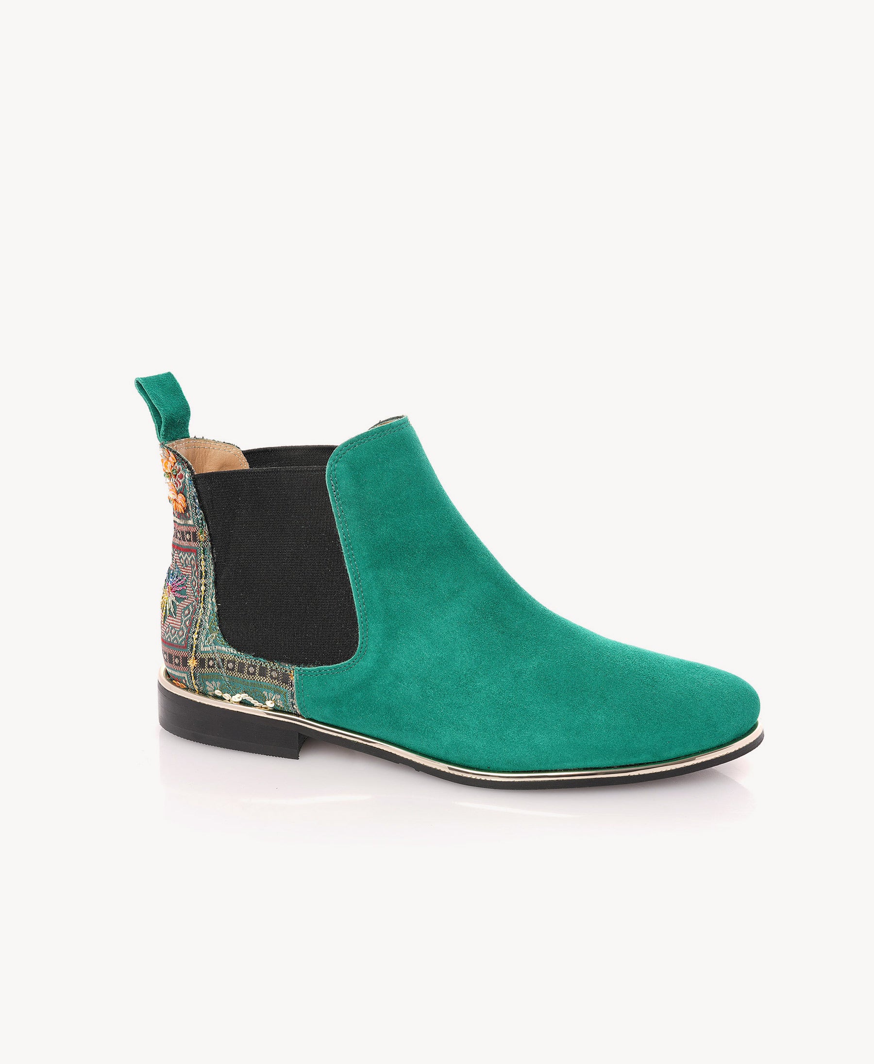 A single teal green suede Chelsea boot with a black elastic side panel and a multicolor patterned heel tab, shown from a side profile on a light gray background.