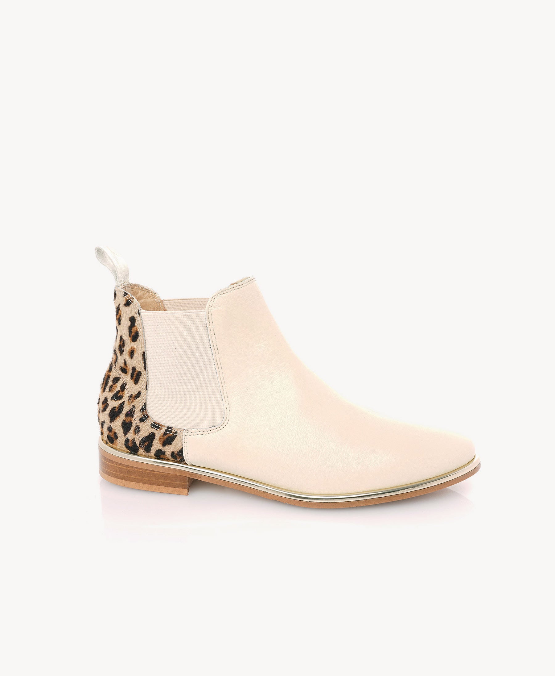 A single women's ankle boot in pale blush pink faux leather with a leopard-print elastic side panel and pull tab, shown from a side profile on a light gray background.