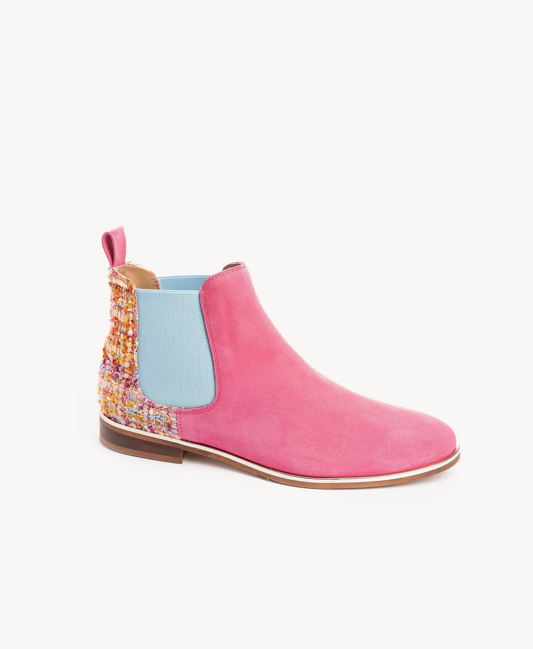 A pink suede Chelsea boot with a light blue elastic side panel and a multicolor tweed heel detail, shown against a plain white background.